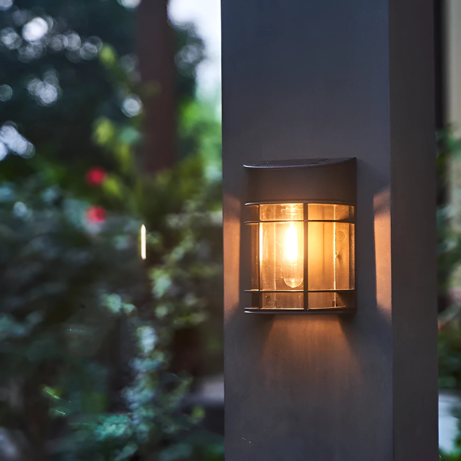 Solar-powered outdoor wall light with warm white LED, mounted on a garden wall.