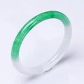 Jade bracelet with floating flower design and auspicious cloud patterns in ice-like emerald appearance