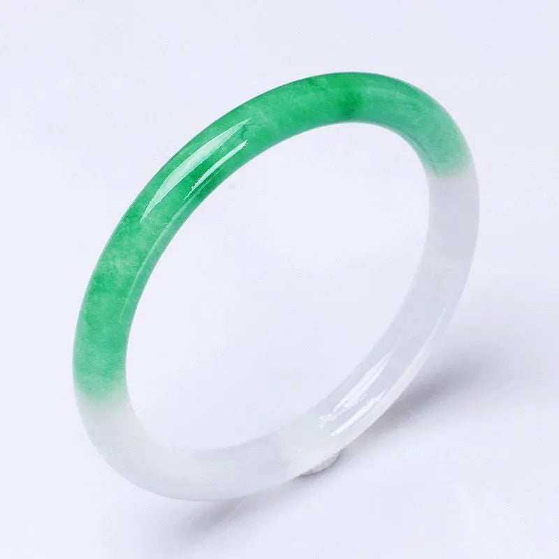 Jade bracelet with floating flower design and auspicious cloud patterns in ice-like emerald appearance