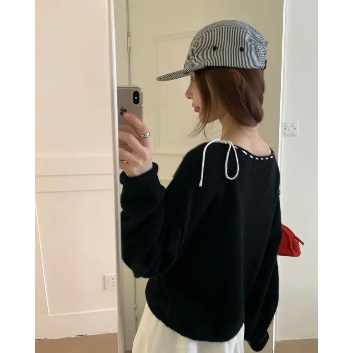 Grey loose-fitting women's long-sleeve knitwear pullover on a hanger.