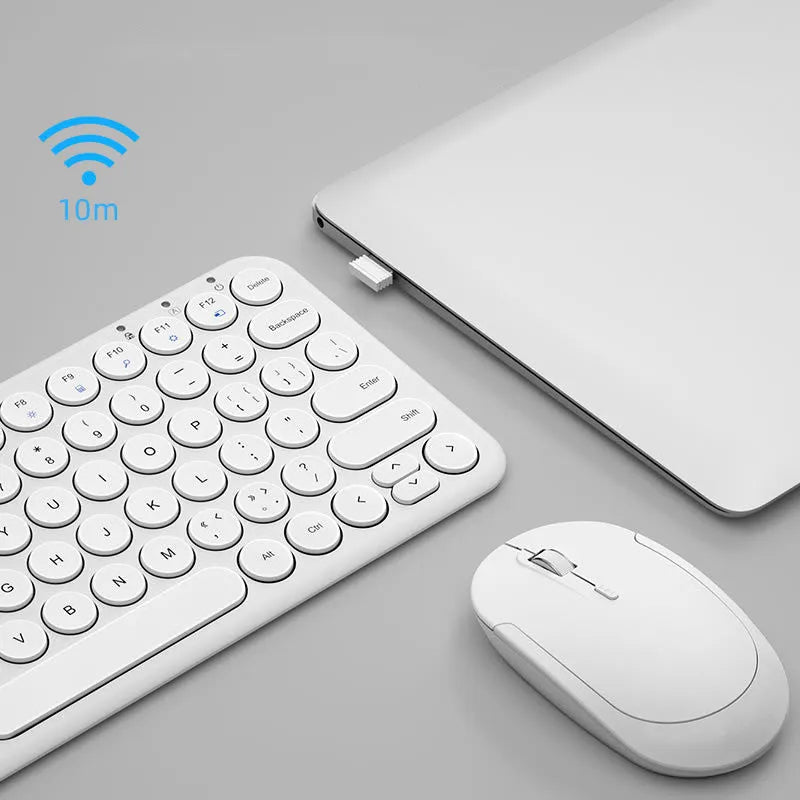 White ultra-thin wireless keyboard and mouse set with USB nano receiver on a wooden desk.
