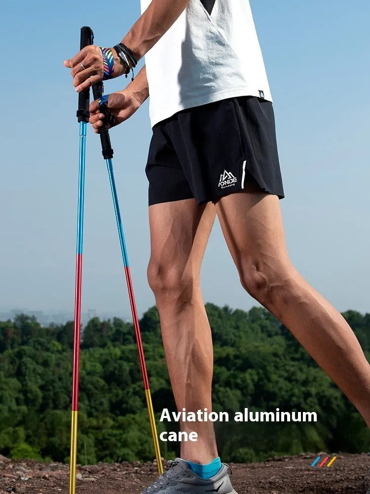 Pair of carbon fibre folding trekking poles with tungsten steel tips in colourful finish for hiking