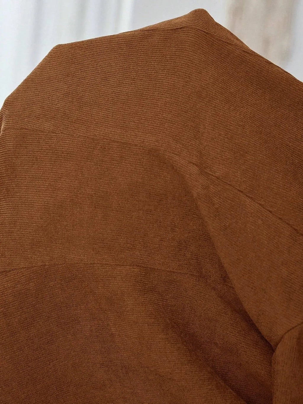 Brown men's single-breasted lapel leisure suit coat on a hanger.