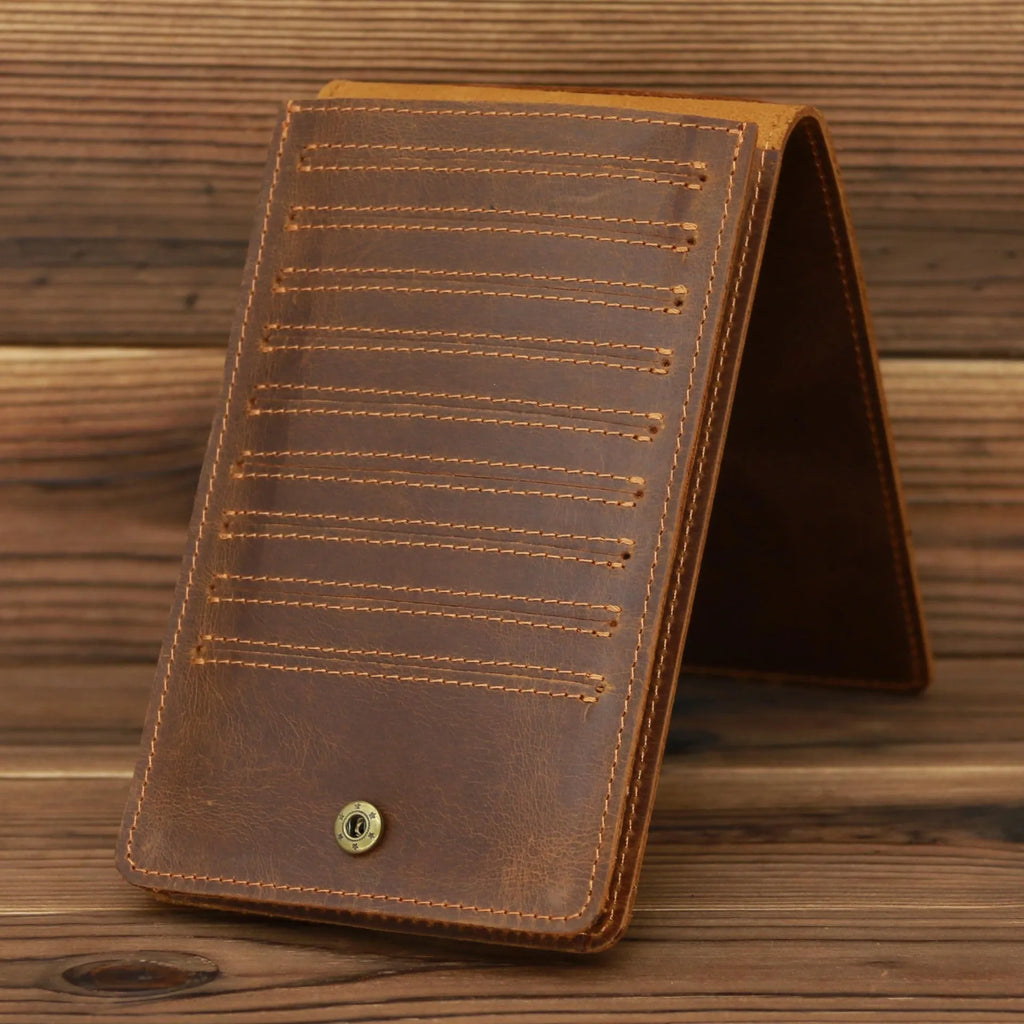 Slim brown cowhide men's wallet open to show 18 card slots and a phone compartment.