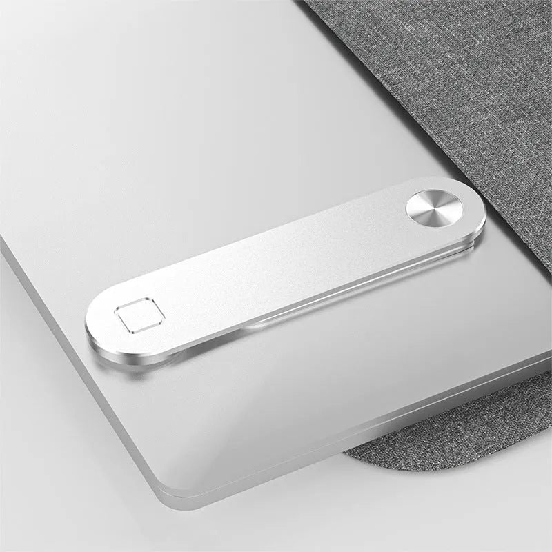 Black aluminium laptop phone holder clipped to side of monitor with smartphone attached.