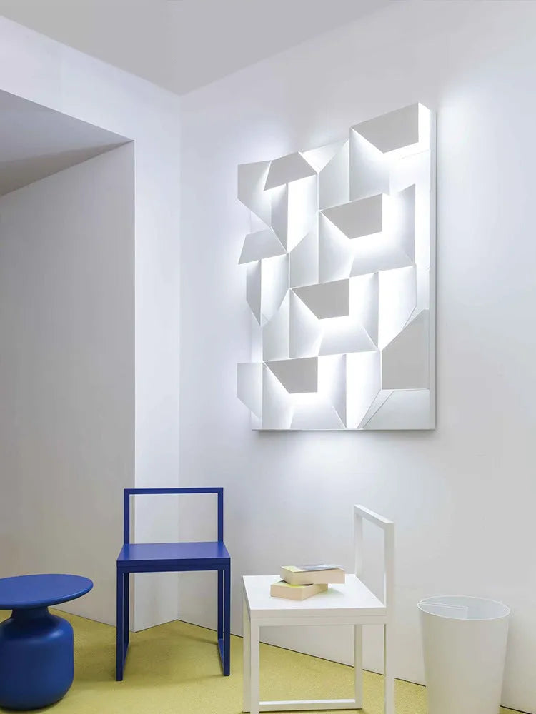 Minimalist rectangular wall lamp in matte white finish, shown in a living room setting.