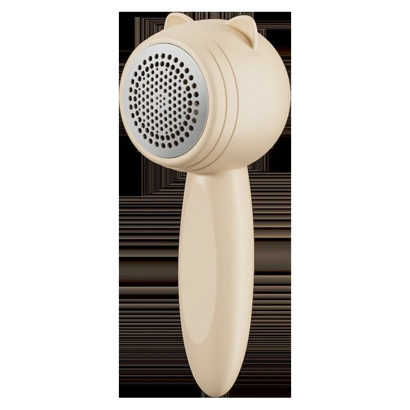 Small cat portable rechargeable lint remover in cream colour on fabric surface