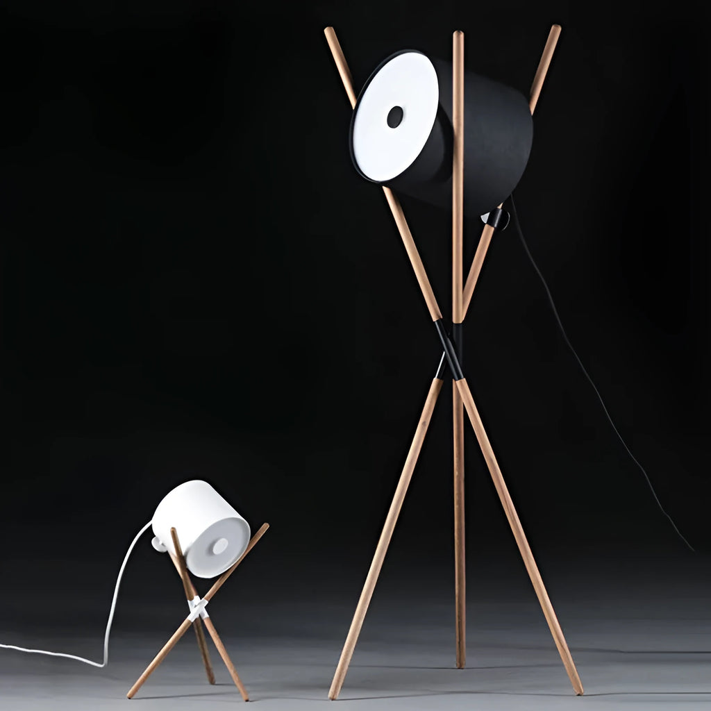 Modern three fork floor lamp in natural wood with acrylic shade on a living room floor.