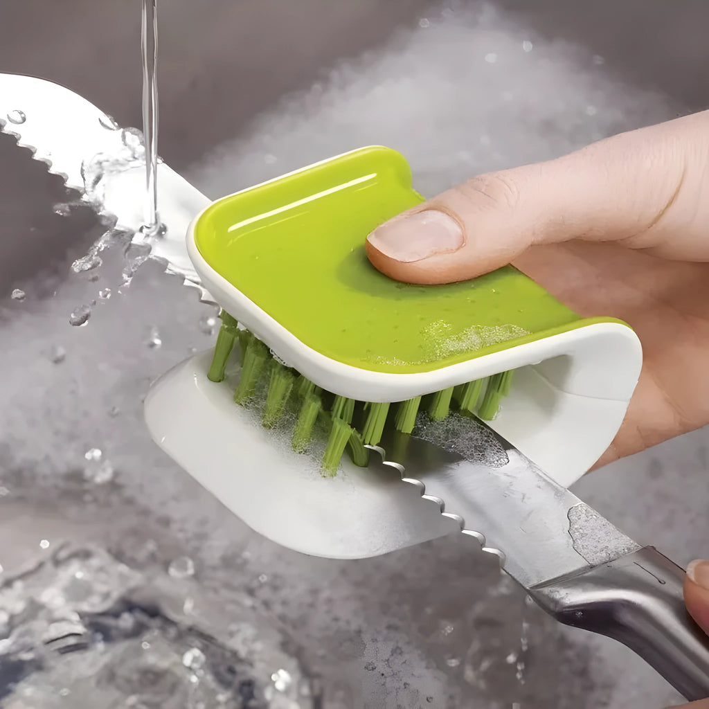 Blue U-shaped plastic brush for cleaning kitchen forks, knives and spoons on a countertop.