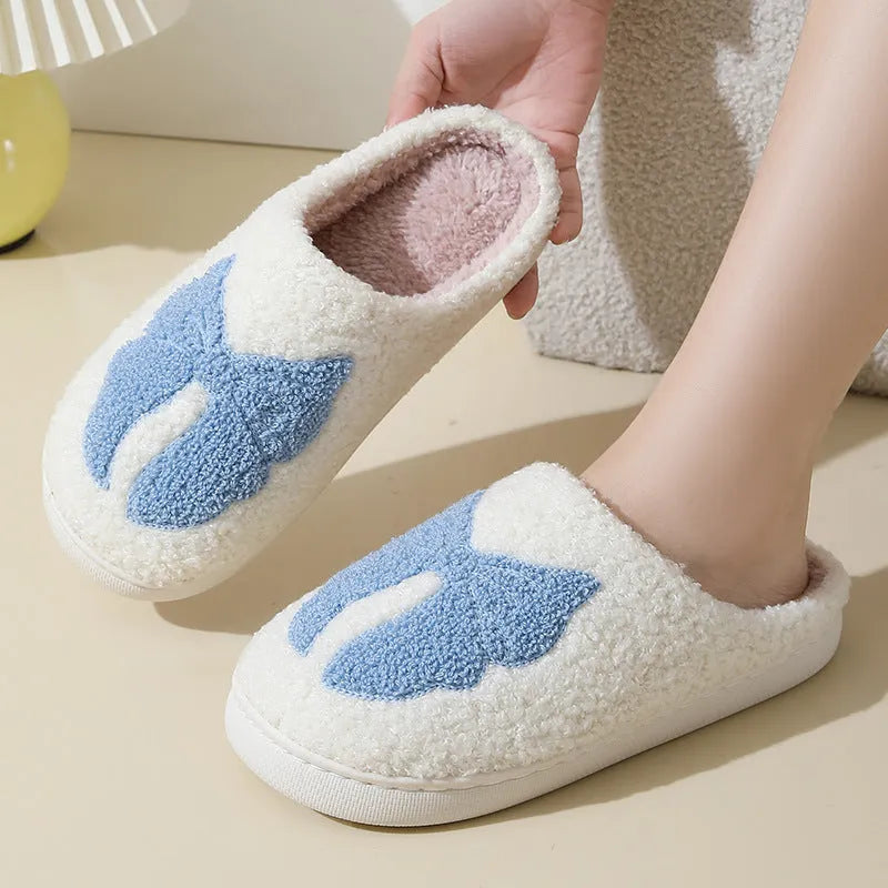 Pink and blue cotton suede slippers with a cartoon bow knot design and TPR sole.