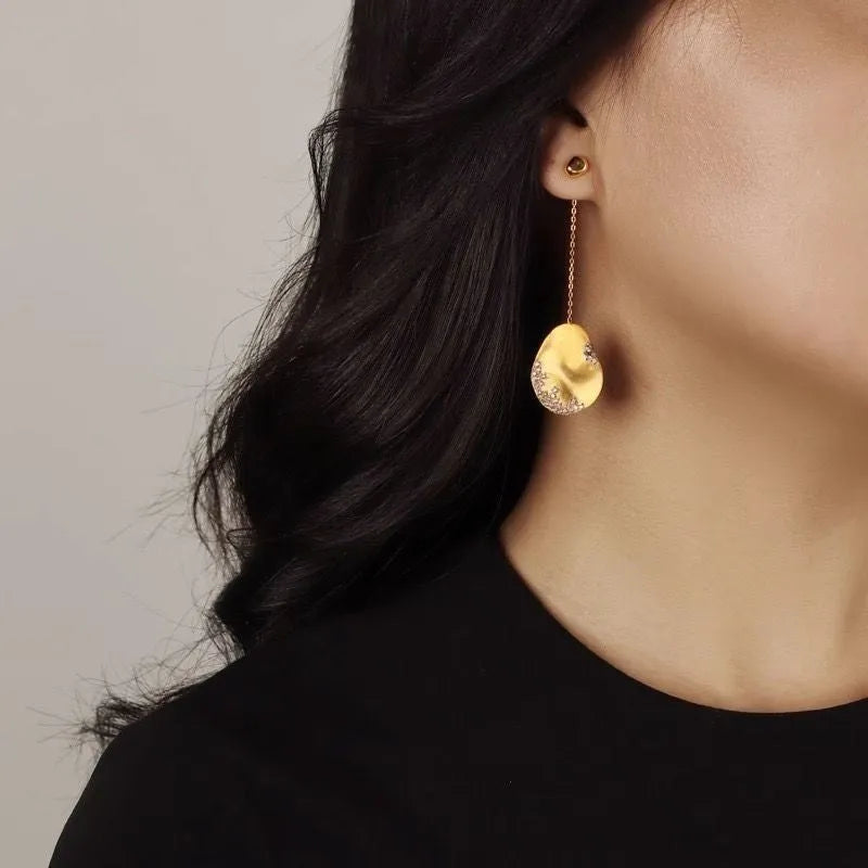 Asymmetric floral earrings with zircon crystals in gold or silver colour options