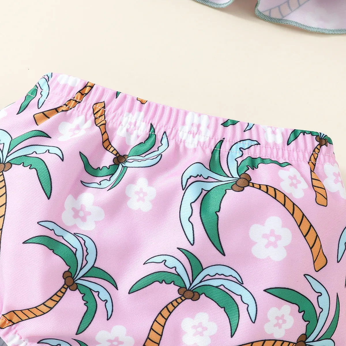 Toddler girl's white two-piece swimsuit set with shirt top and matching shorts