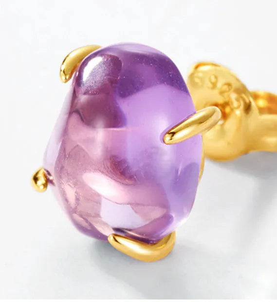 Natural powder amethyst stud earrings in 925 silver with four-claw setting and electroplated finish, one pair