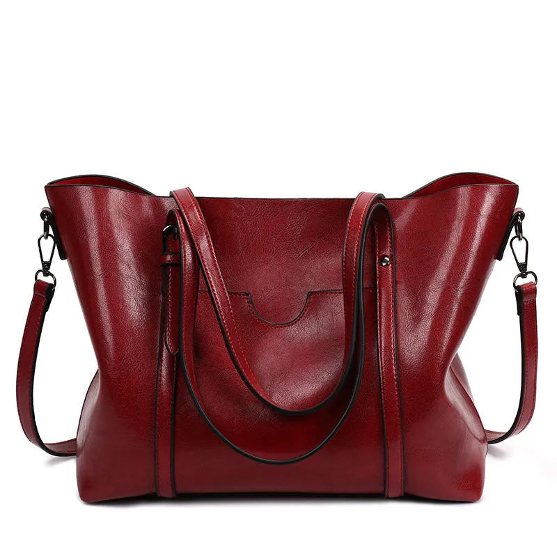 Retro-style brown PU messenger bag with top handles and a shoulder strap, shown open to reveal polyester cotton lining.