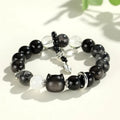 Silverstone crystal beaded bracelet with fox, cat head, and planet charms in white, pink, navy blue, and black.