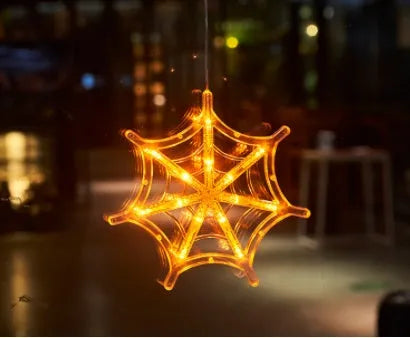 Halloween LED window lights with suction cups showing ghost, spider, and pumpkin decorations