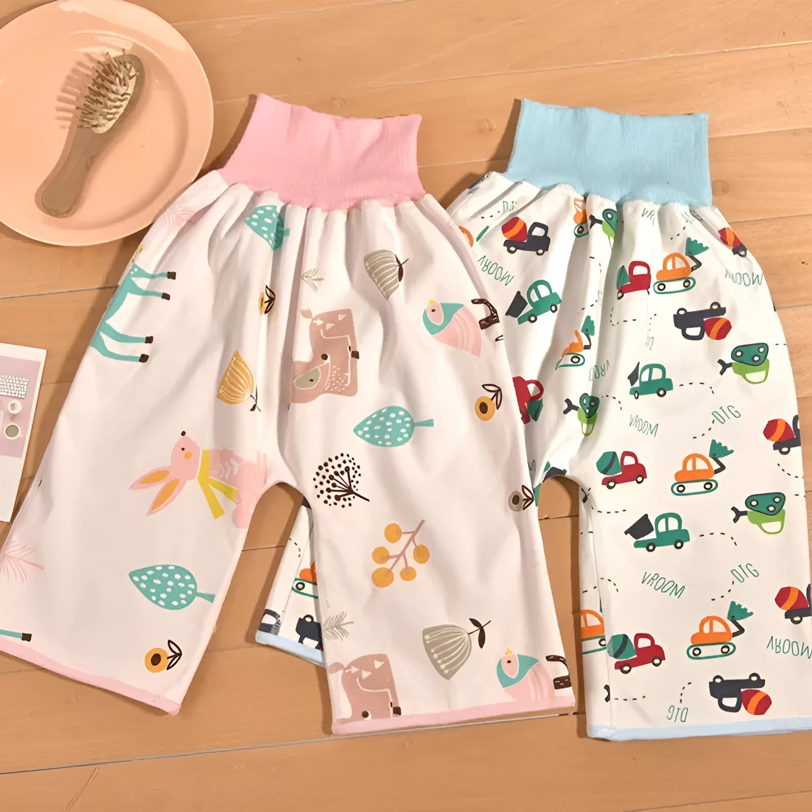 High waist baby diaper training pants in cotton bamboo fabric with cartoon print, showing wide elastic band.
