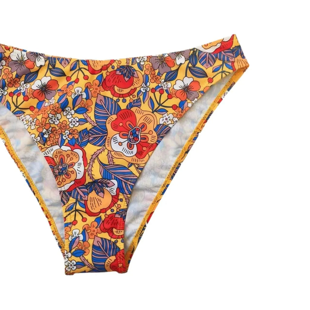 Plus size women's floral print strap bikini swimsuit set in brief style on a mannequin