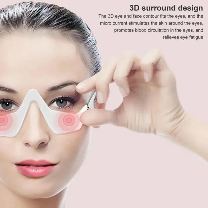 Pink and white micro-current eye massager with glasses-style design for wrinkle reduction and dark circle removal