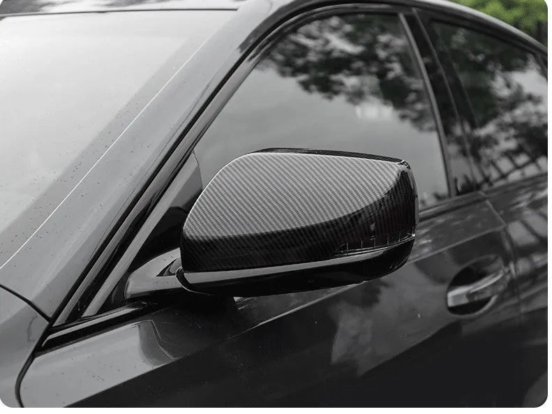 Pair of black ABS rearview mirror covers with carbon fibre pattern for Cadillac CT5 CT6.