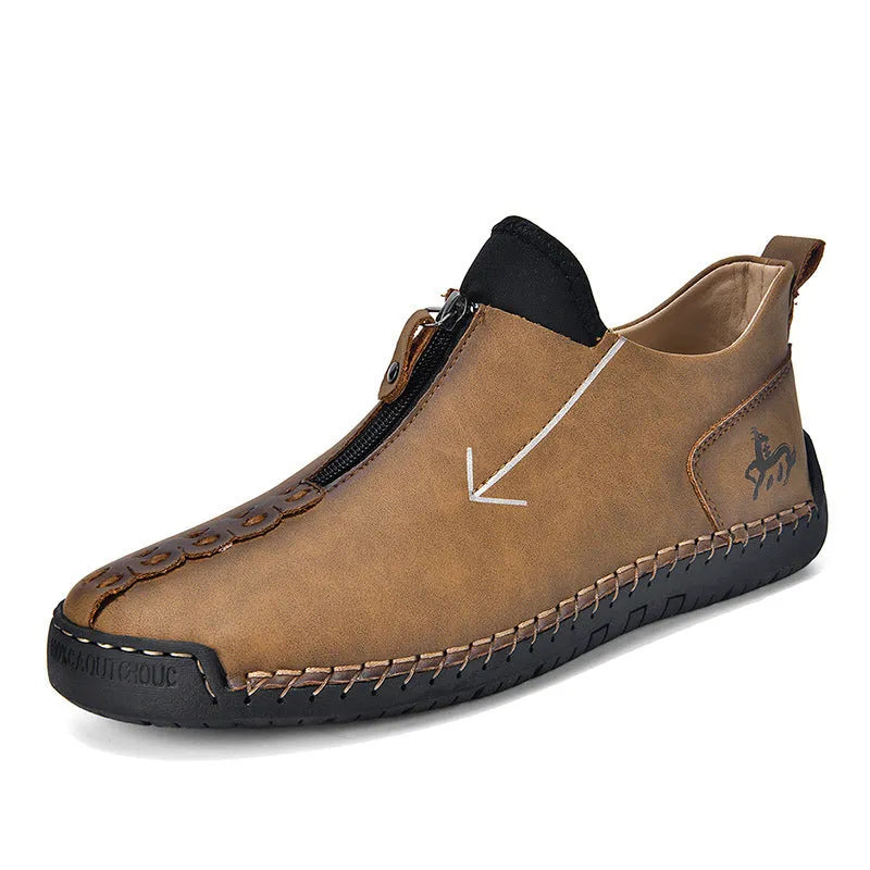 Men's black leather martin boots with a front zipper and round toe on a rubber sole.