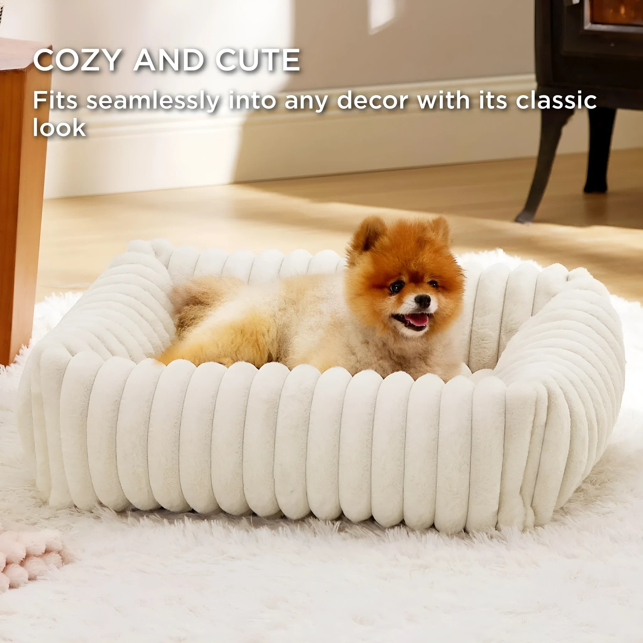 Beige plush pet bed with raised bolster sides for cats and dogs, shown in a home setting.