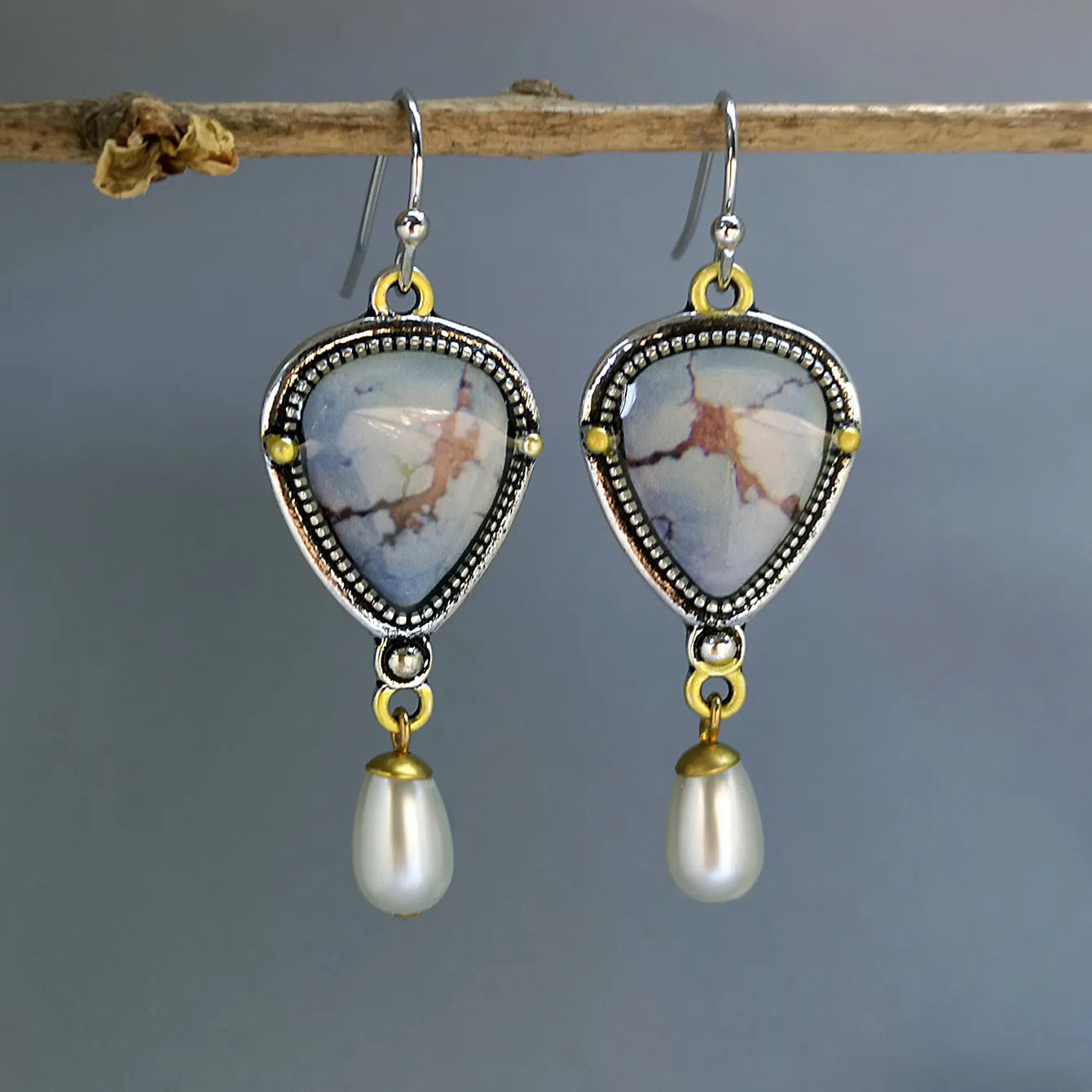 Retro blue geometric drop earrings with synthetic opal and pearl accents on white background