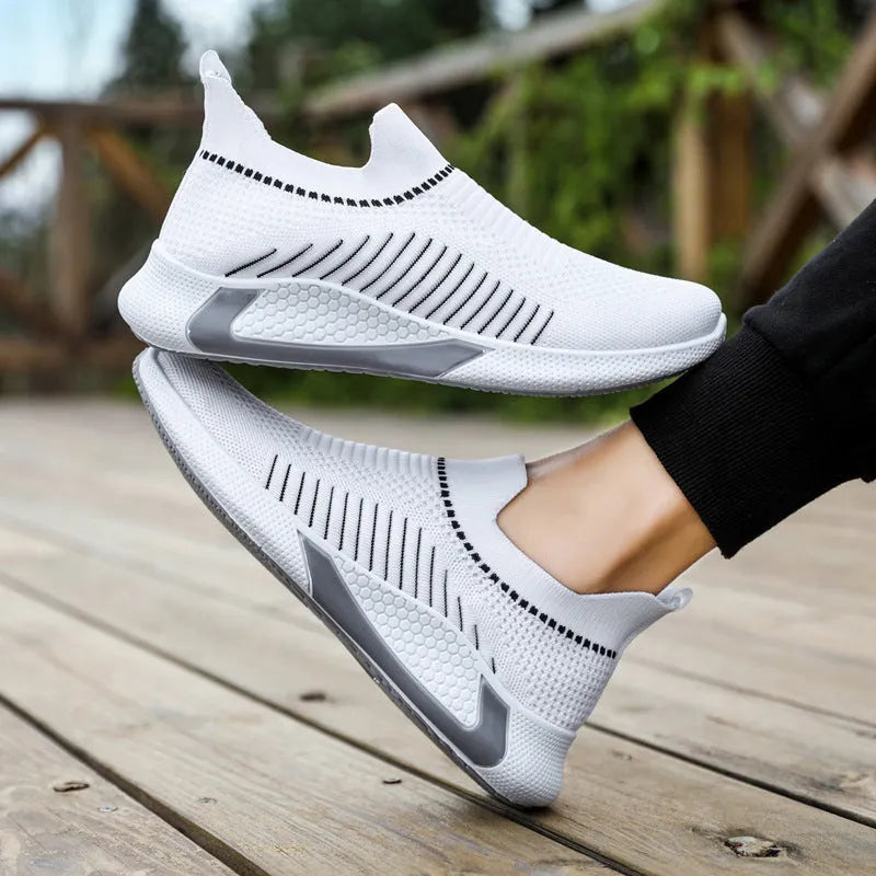 Men's low-cut sneakers with striped Flyknit upper, mesh lining, and flat plastic sole.