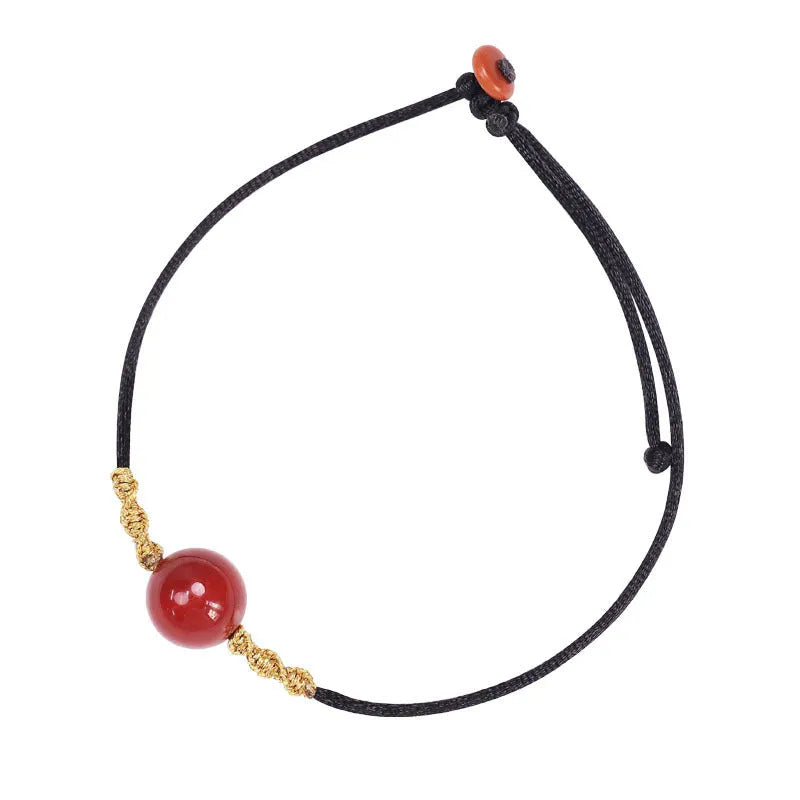 Hand-woven red agate bracelet and necklace set showing bean bead elements
