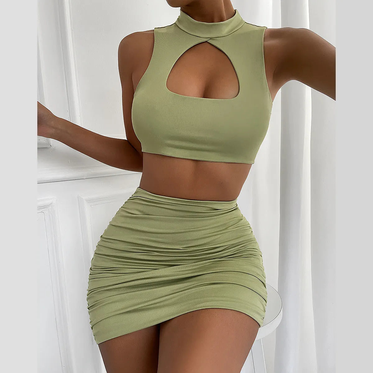 Women's light purple elastic polyester two-piece set with hollow vest top and matching hip skirt