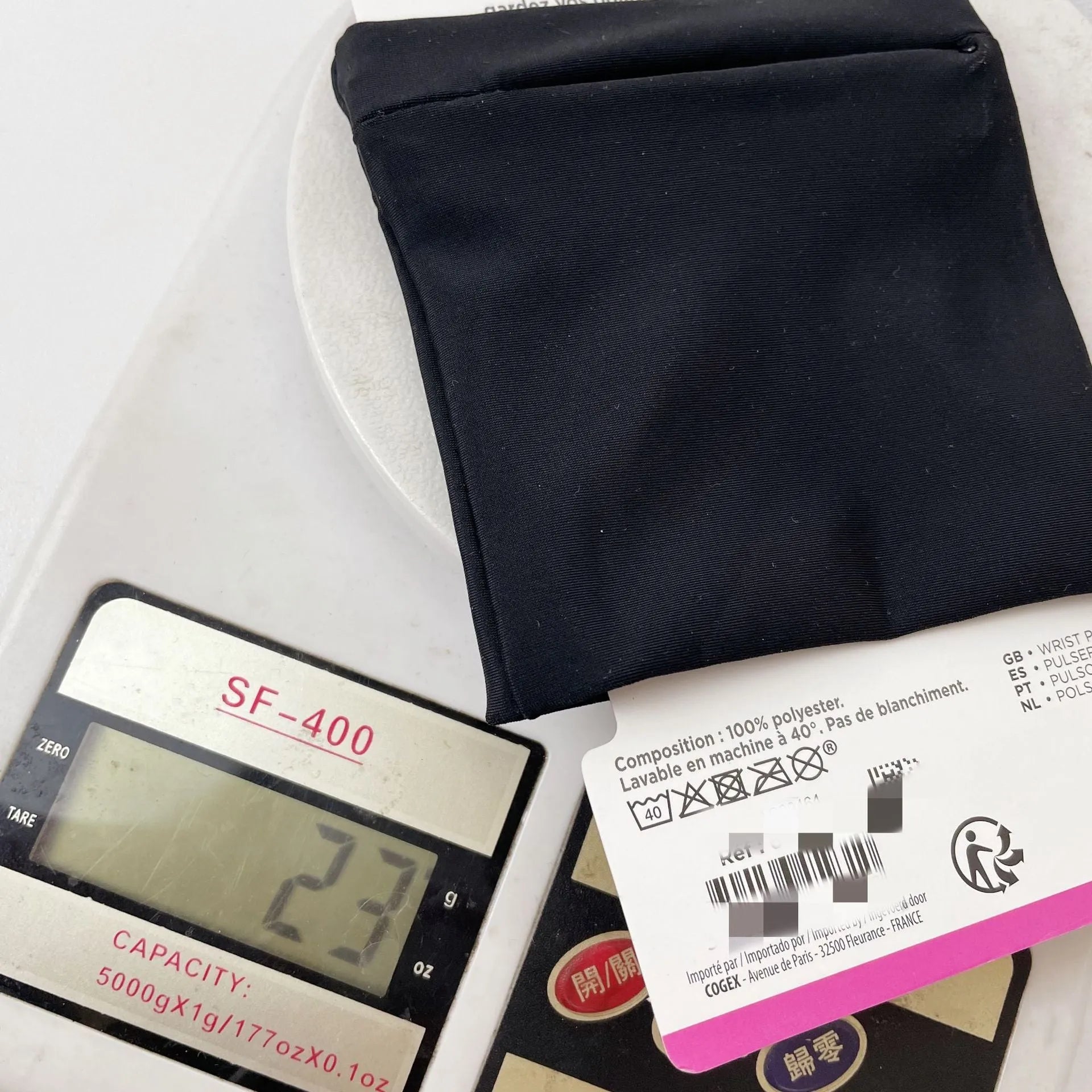 Black wrist armband with adjustable strap and a 10cm by 10.5cm main compartment for a mobile phone.