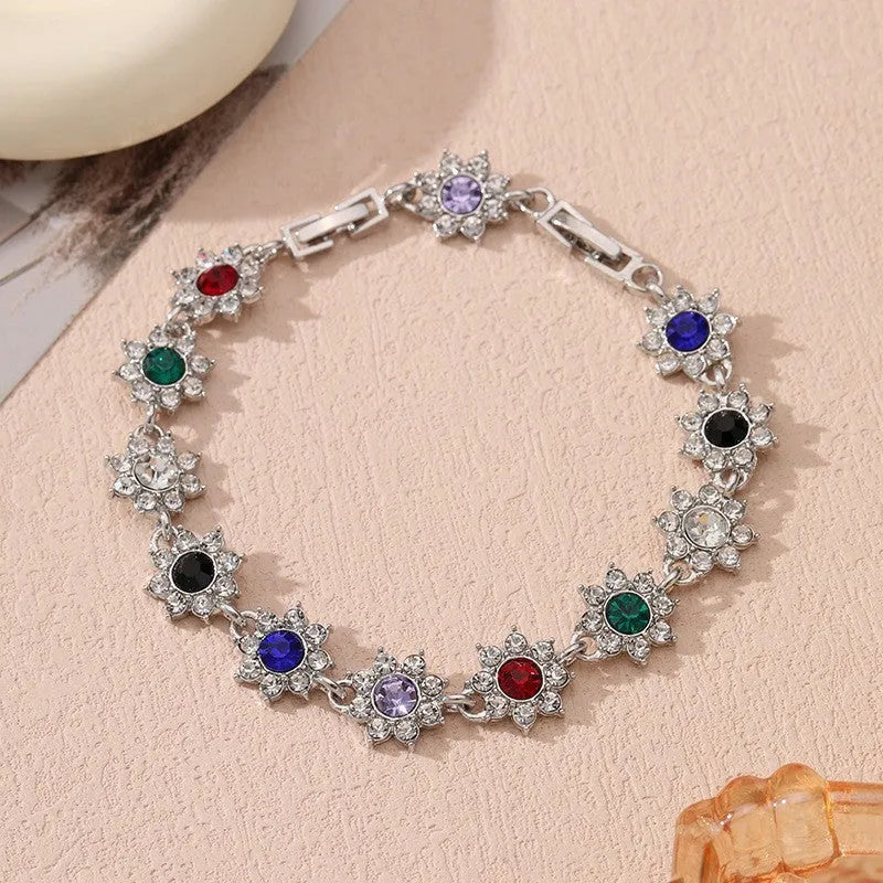 Coloured gemstone bracelet with flower-shaped design in gold and silver colour variations