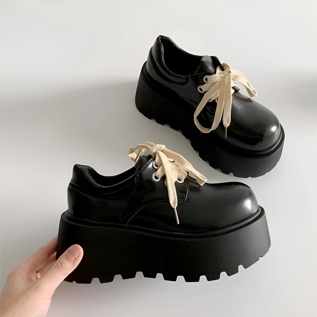 Women's matte black retro lace-up shoes with a thick rubber sole and buckle closure.