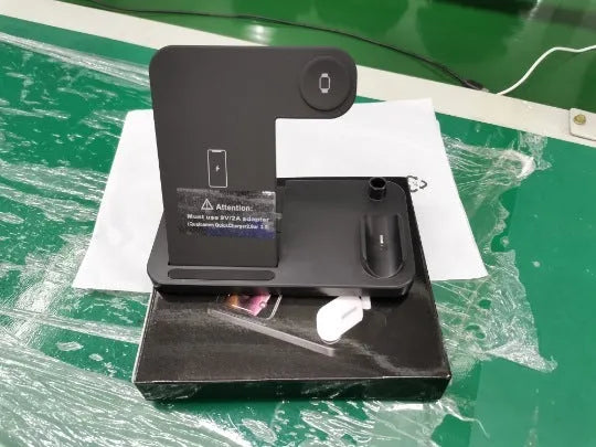 Folding 4-in-1 wireless charger in space grey, showing iPhone on vertical stand and Apple Pencil on magnetic charger.