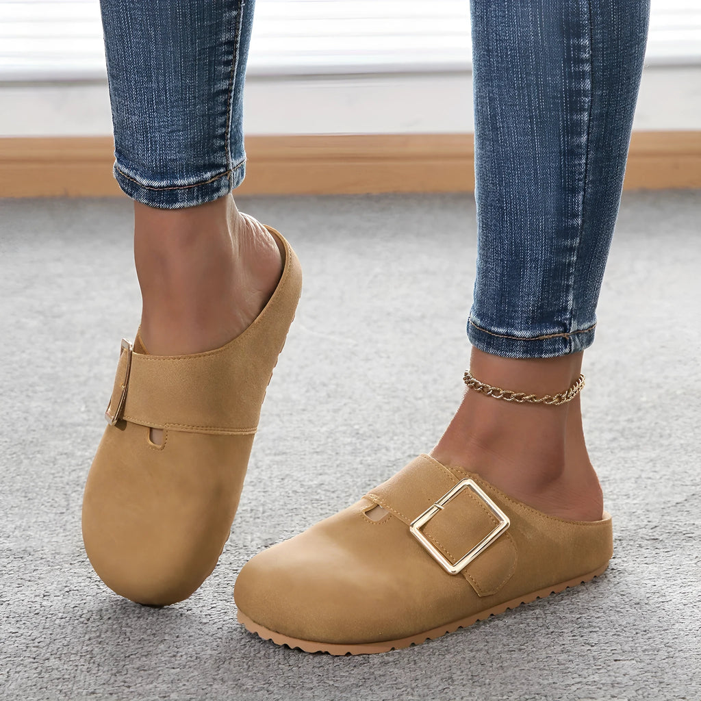 Women's brown closed toe canvas slippers with low top design showing pull-on style and textured canvas upper
