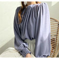 High-neck chiffon shirt with puff sleeves, asymmetric shoulder and loose woven acrylic fit, shown in black
