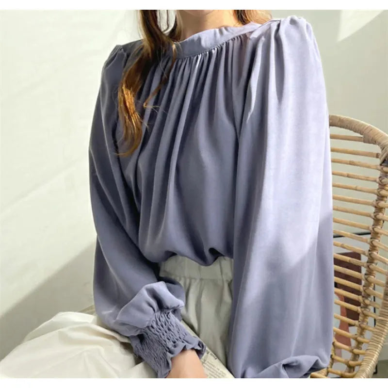 High-neck chiffon shirt with puff sleeves, asymmetric shoulder and loose woven acrylic fit, shown in black