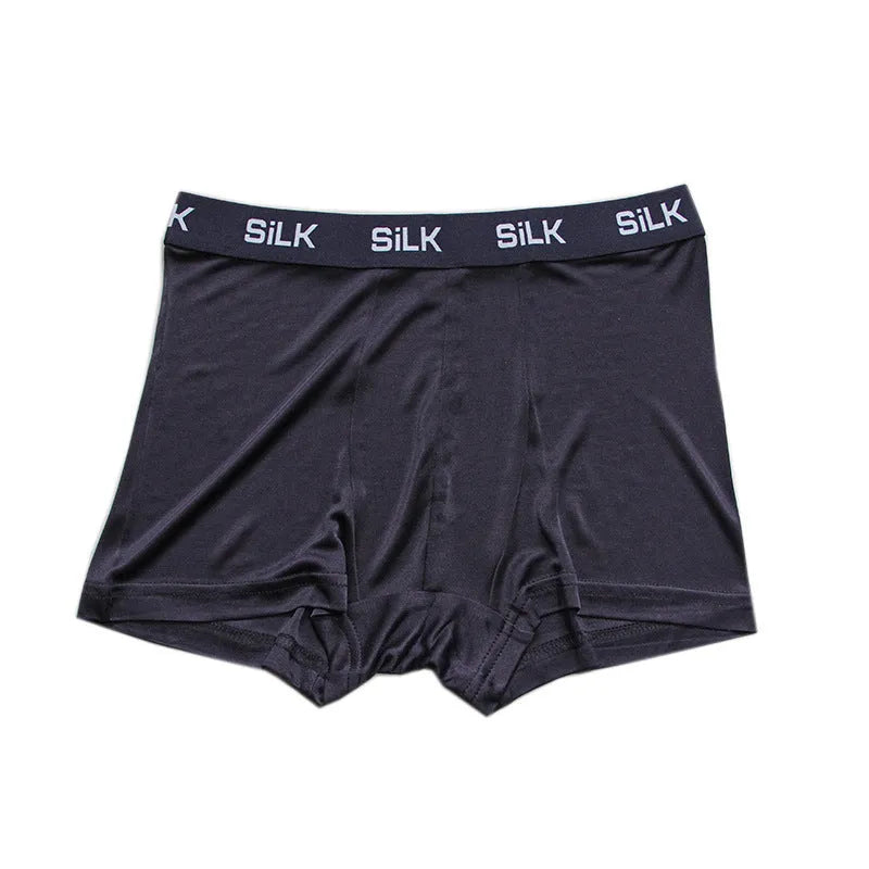 Men's loose fit silk shorts in navy blue, shown from the front on a mannequin.
