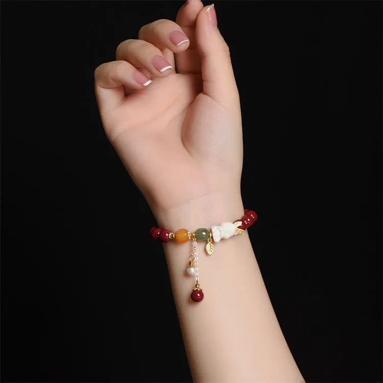 Natural cinnabar bracelet with rabbit design in purple gold sand colour, showing 8mm and 10mm bead size options.