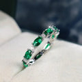Copper ring with green and white zircon inlay geometric design on finger