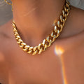 Gold tone women's necklace with thick 6cm chain links on a 32cm alloy chain, electroplated finish.