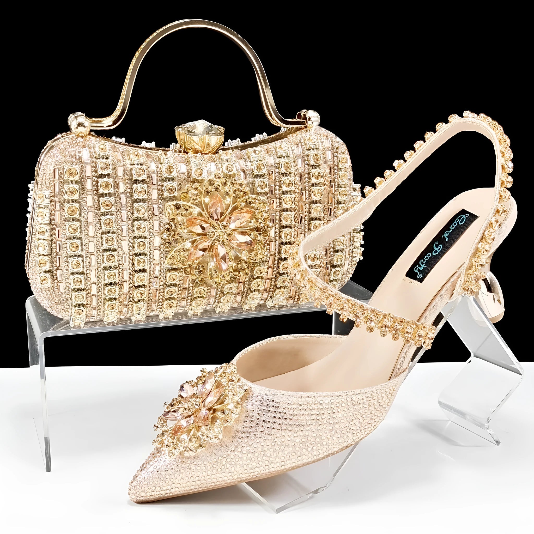 Black high heel ankle strap shoes with floral buckle and matching rhinestone clutch bag.