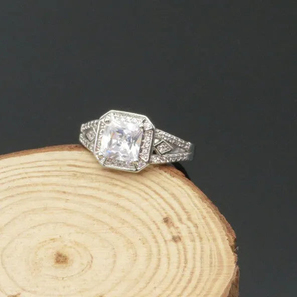 Platinum-colour hollow geometric ring with an inlaid cubic zirconia stone, shown from the side.