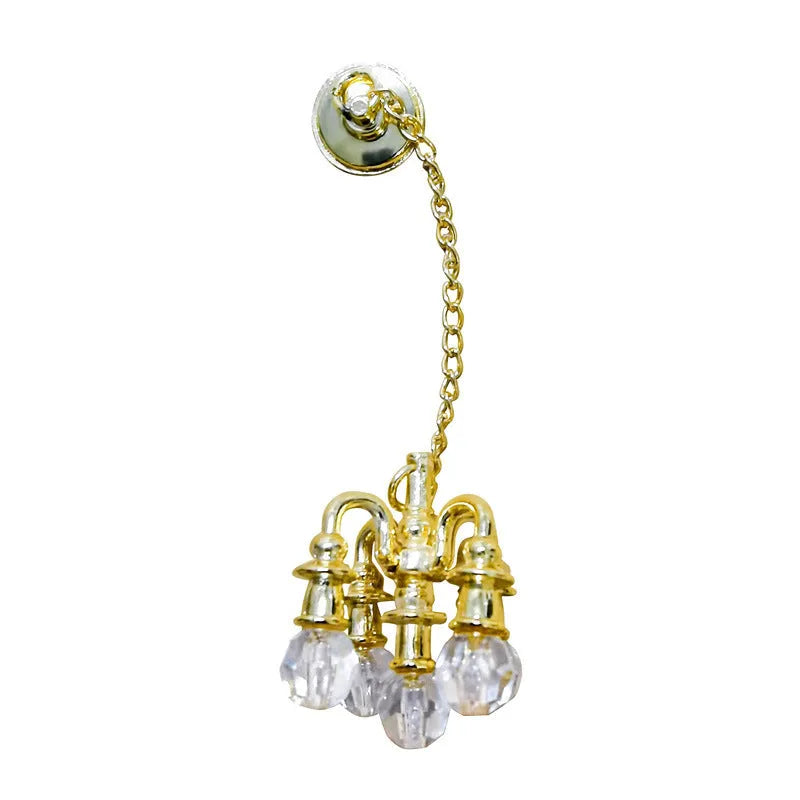 A small gold or silver metal photo prop decoration measuring 5 by 2 centimetres.