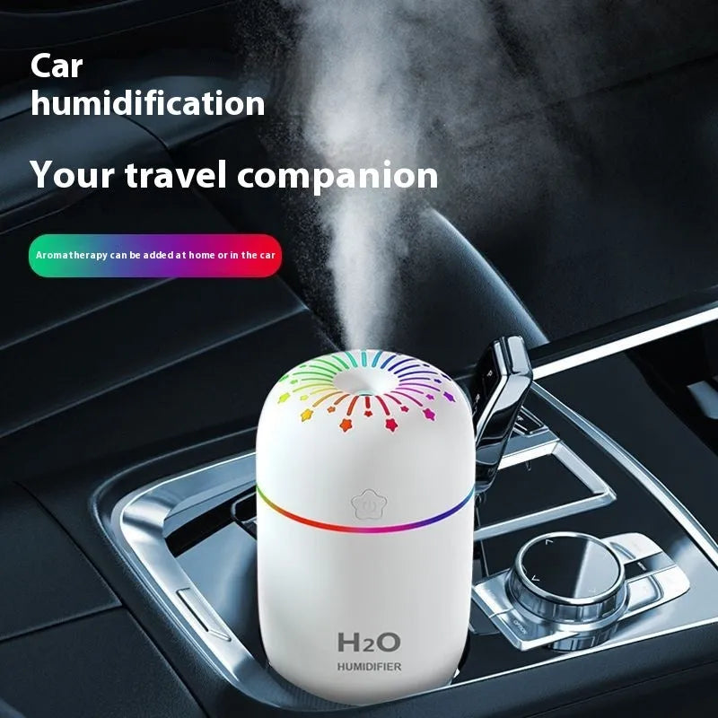 White A5 model mini USB humidifier with 300ml tank on a desk next to a laptop.