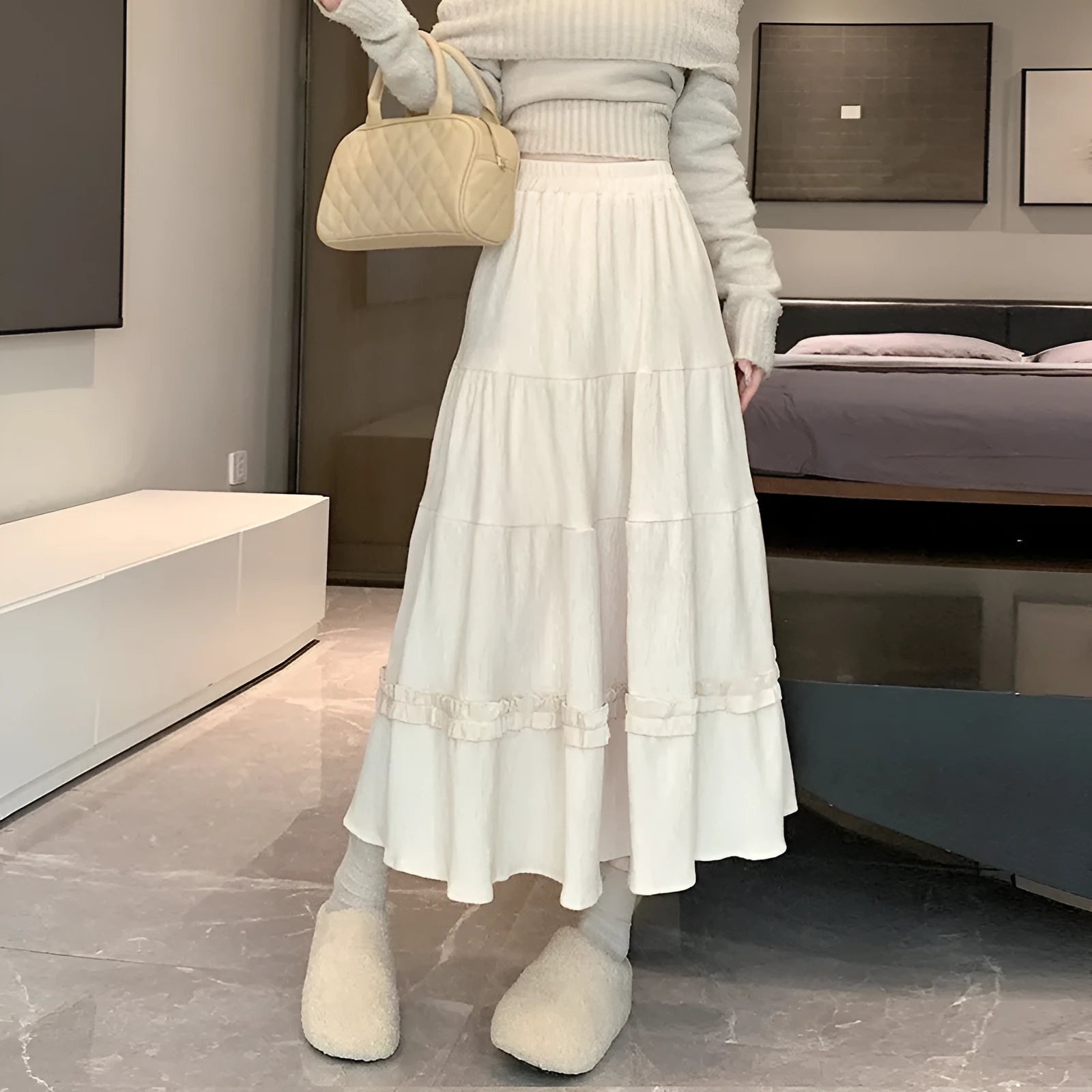 Corduroy midi A-line skirt with elastic waistband in milk white, shown on a model.