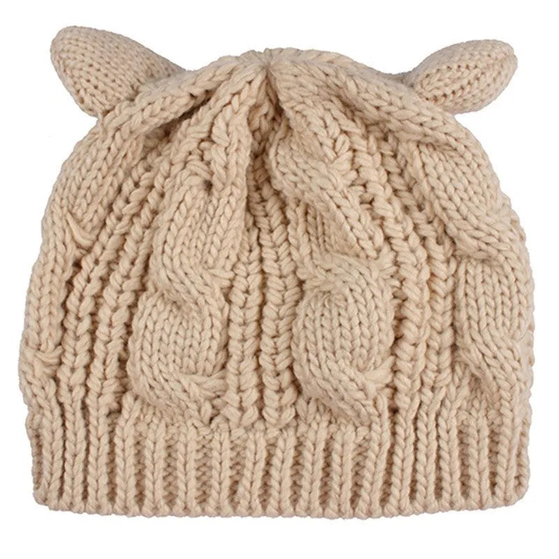 Hand-made knitted beanie with 3D cat ears in red wool, shown on a head.