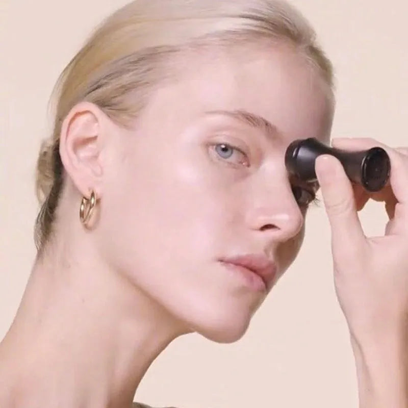A small portable volcanic stone roller for absorbing facial oil, shown in various colours on a neutral background.