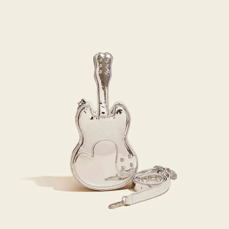 Guitar-shaped silver crossbody shoulder bag with a black strap.