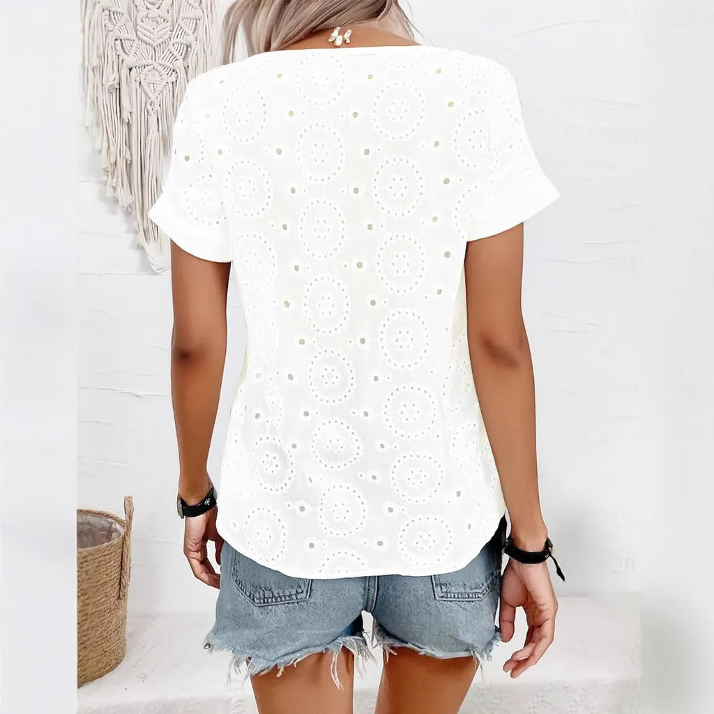 White loose V-neck t-shirt with hollow-out pattern detail on front, short sleeves, casual fit.
